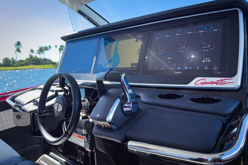 Slide: The Image of 2025 Cigarette 41 Nighthawk boat dashboard with advanced navigation screens. - 66