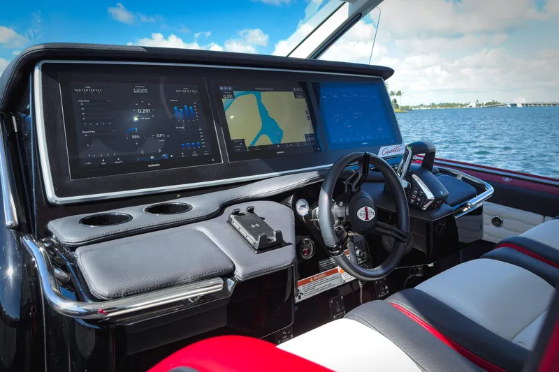 Slide: The Image of 2025 Cigarette 41 Nighthawk boat dashboard with advanced navigation screens and controls. - 68