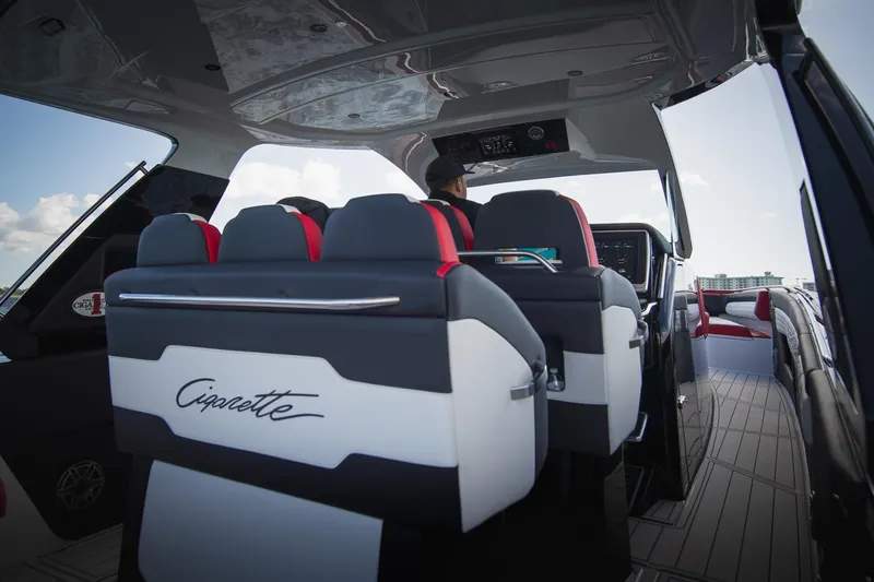 Slide: The Image of 2025 Cigarette 41 Nighthawk boat interior with modern seating and dashboard. - 8