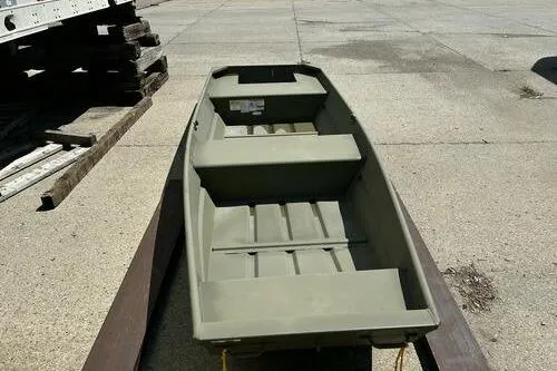 Slide: The Image of 2025 Tracker Grizzly 14 Jon boat on concrete surface, showcasing its sturdy design. - 4