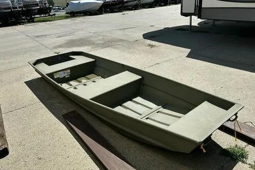 Slide: The Image of 2025 Tracker Grizzly 14 Jon boat in a parking lot, showcasing its sturdy design. - 5
