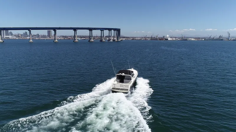 Slide: The Image of A 1988 Californian Veneti boat cruising near a bridge on a sunny day. - 12