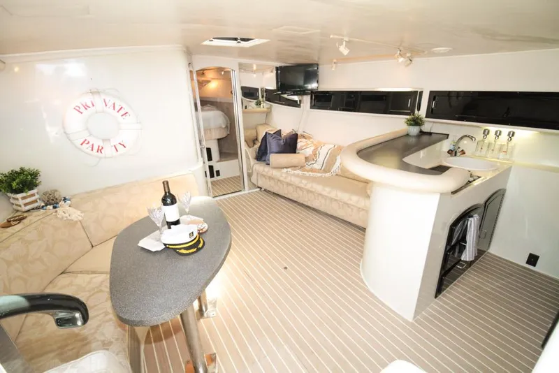 Slide: The Image of Luxurious 1988 Californian Veneti yacht interior with cozy seating, bar, and nautical decor. - 20