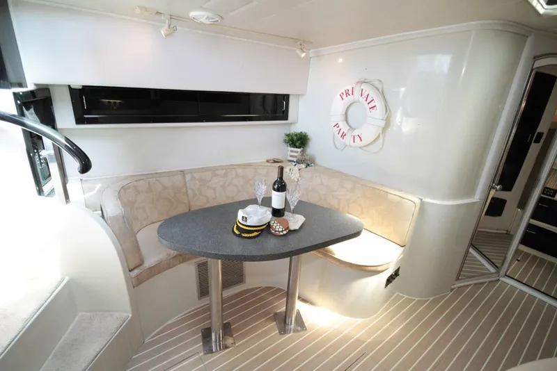 Slide: The Image of 1988 Californian Veneti yacht interior with dining area, wine, and nautical decor. - 24