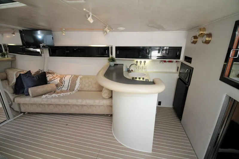 Slide: The Image of Luxurious interior of a 1988 Californian Veneti yacht with a cozy lounge and bar area. - 25