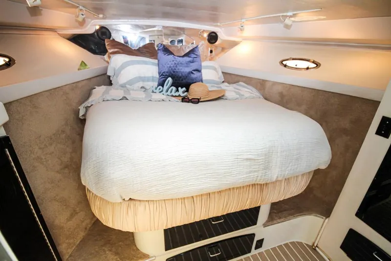 Slide: The Image of Cozy cabin interior of 1988 Californian Veneti boat with bed and decorative pillows. - 29