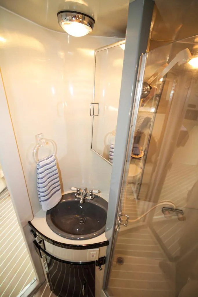 Slide: The Image of 1988 Californian Veneti bathroom with sink, mirror, and shower in compact, modern design. - 31