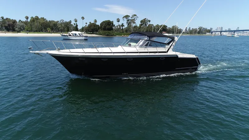 Slide: The Image of 1988 Californian Veneti yacht cruising on a sunny day in a scenic waterway. - 4