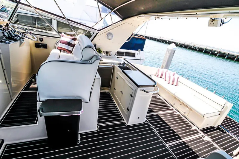 Slide: The Image of Luxurious 1988 Californian Veneti yacht interior with seating, striped cushions, and ocean view. - 41