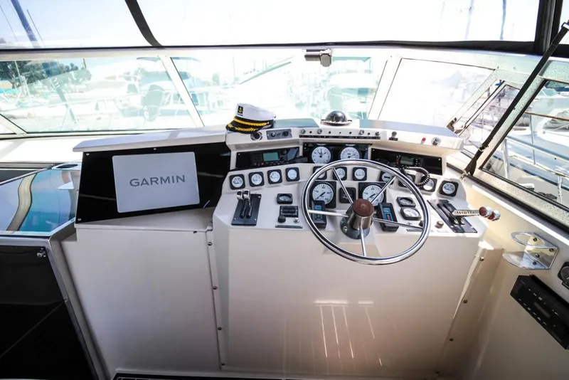 Slide: The Image of 1988 Californian Veneti boat cockpit with Garmin navigation, steering wheel, and captain's hat. - 42