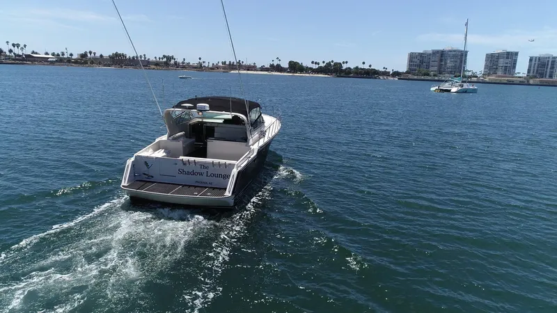 Slide: The Image of 1988 Californian Veneti boat cruising on a sunny day in a coastal marina. - 8