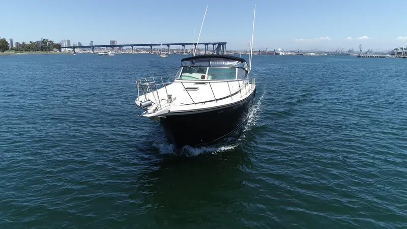 Slide: The Image of 1988 Californian Veneti boat cruising on open water with cityscape in background. - 9