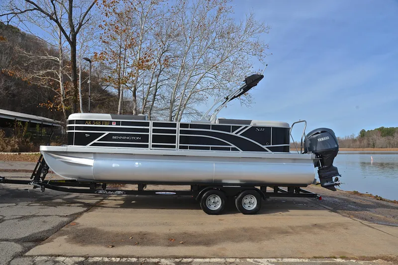 Slide: The Image of 2025 Bennington 22 S pontoon boat on trailer by a lake. - 11