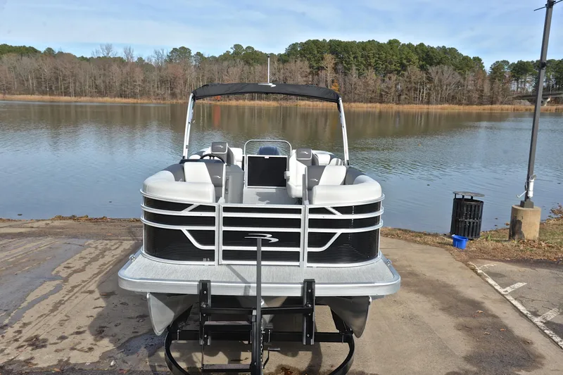 Slide: The Image of 2025 Bennington 22 S pontoon boat on a lakefront ramp. - 17