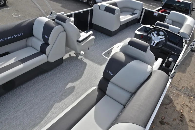 Slide: The Image of 2025 Bennington 22 S pontoon boat interior with modern seating and steering console. - 19