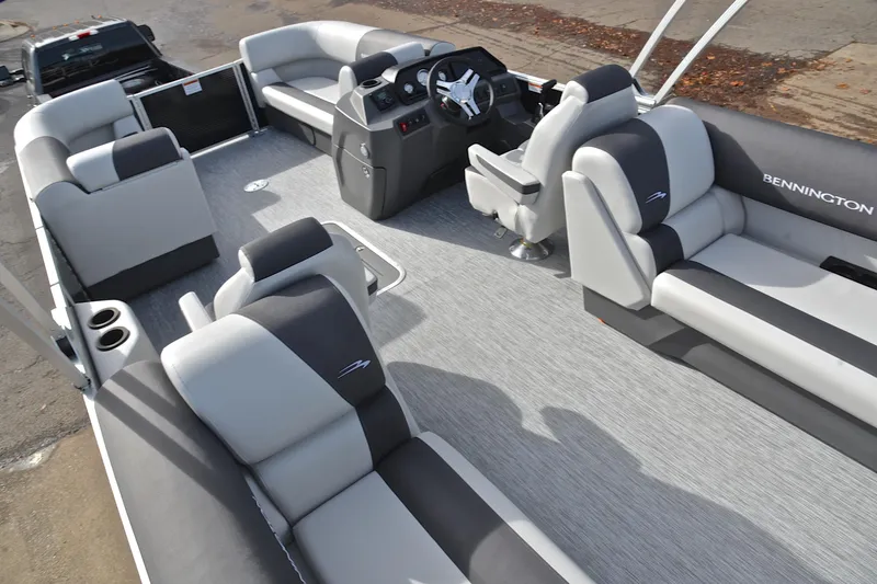 Slide: The Image of 2025 Bennington 22 S pontoon boat interior with gray seating and steering console. - 25