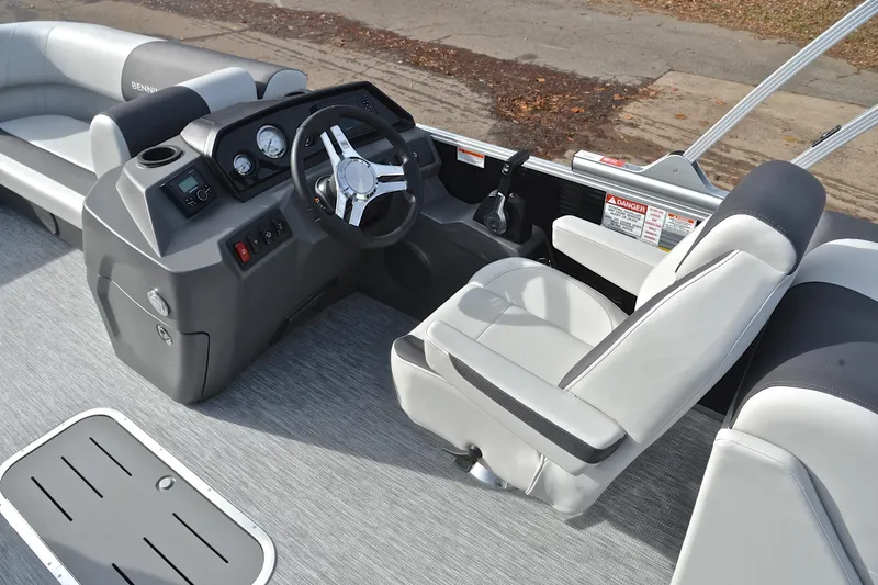 Slide: The Image of 2025 Bennington 22 S boat interior with steering wheel and seating. - 26