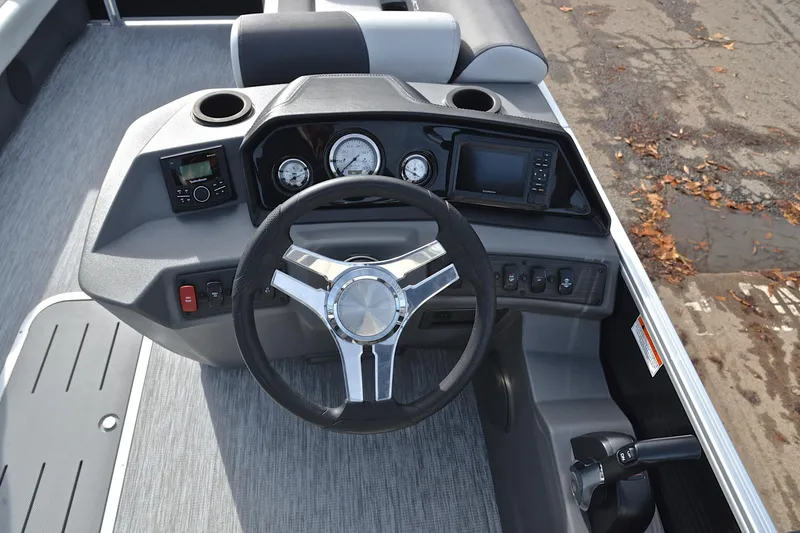 Slide: The Image of 2025 Bennington 22 S boat dashboard with steering wheel and control panel. - 27