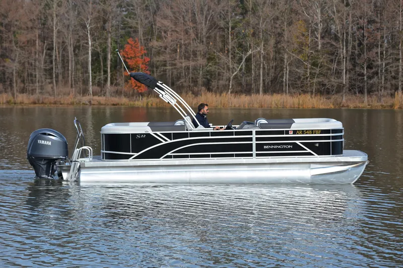 Slide: The Image of 2025 Bennington 22 S pontoon boat on a calm lake with Yamaha engine. - 6