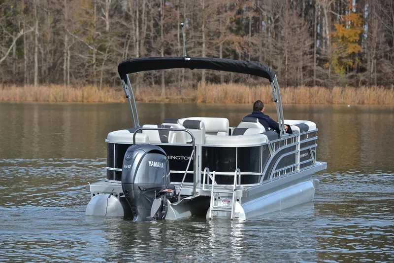 Slide: The Image of 2025 Bennington 22 S pontoon boat cruising on a calm lake. - 7