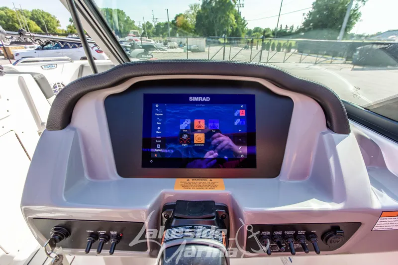Slide: The Image of 2025 Chaparral 21 SSi Ski & Fish OB dashboard with Simrad display and controls. - 21