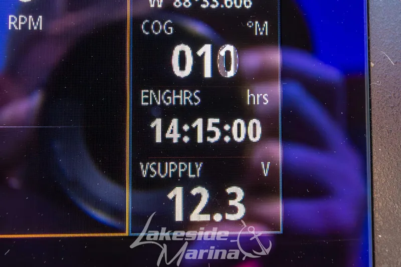 Slide: The Image of Dashboard display of 2025 Chaparral 21 SSi Ski & Fish OB boat, showing engine hours and voltage. - 22