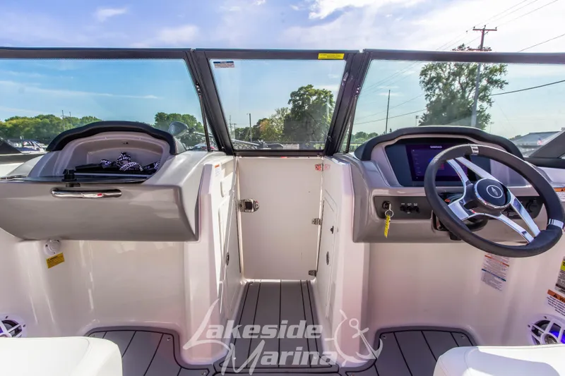 Slide: The Image of 2025 Chaparral 21 SSi Ski & Fish OB boat interior with steering wheel and dashboard. - 25