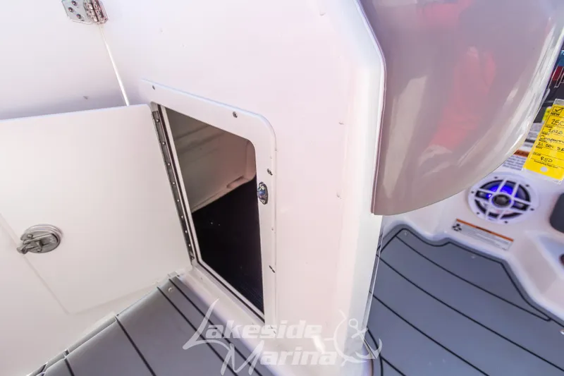 Slide: The Image of 2025 Chaparral 21 SSi Ski & Fish OB boat storage compartment and speaker detail. - 26