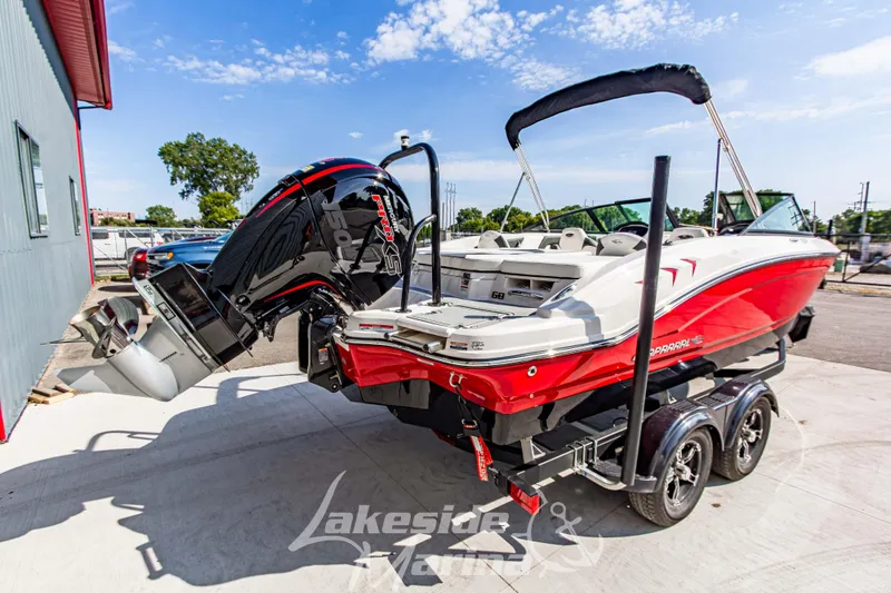 Slide: The Image of 2025 Chaparral 21 SSi Ski & Fish OB boat on trailer, red and white design. - 4