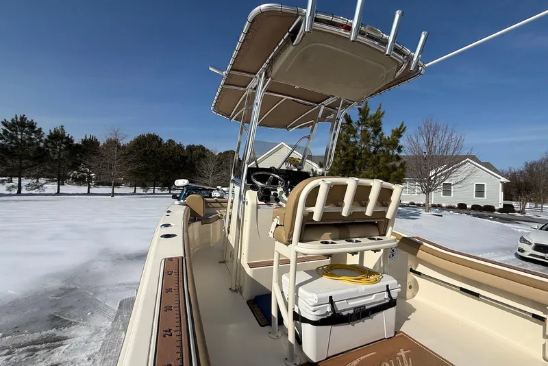 Slide: The Image of 2020 Scout 215 XSF boat with T-top, parked in snowy residential area. - 23