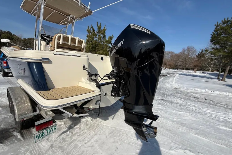 Slide: The Image of 2020 Scout 215 XSF boat with Mercury outboard engine on snowy trailer. - 24