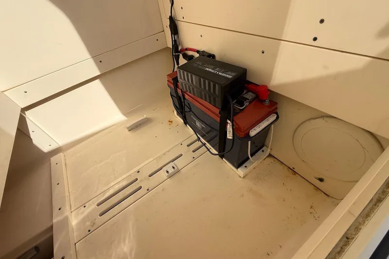 Slide: The Image of 2020 Scout 215 XSF boat battery compartment with installed battery. - 25