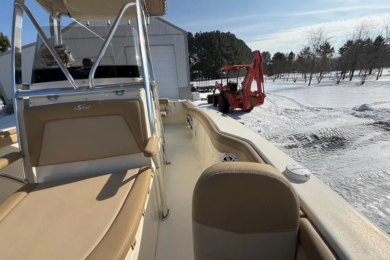 Slide: The Image of 2020 Scout 215 XSF boat with beige seating, parked near snowy landscape and red tractor. - 26
