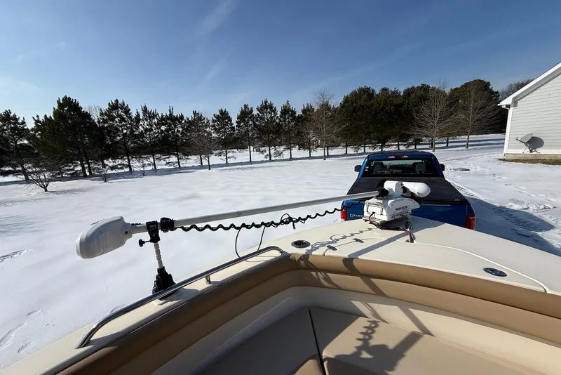 Slide: The Image of 2020 Scout 215 XSF boat on snowy landscape, parked behind a blue truck. - 27