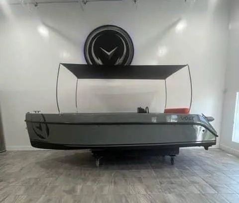 Slide: The Image of 2024 Vision Marine Technologies Volt 180 boat displayed in a showroom. - 4