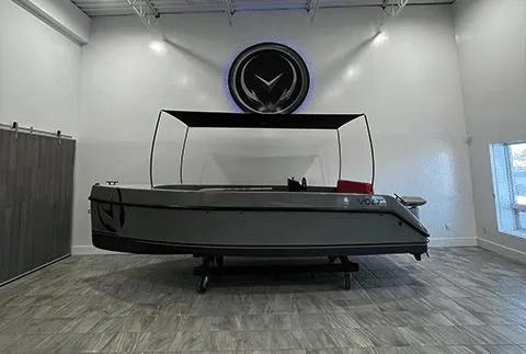 Slide: The Image of 2023 Vision Marine Technologies Volt 180 boat displayed in a modern showroom. - 2