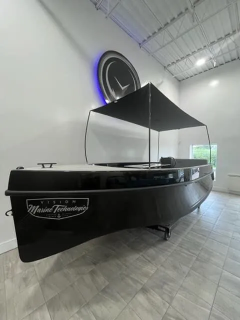 The Image of 2023 Vision Marine Technologies Volt 180 boat displayed indoors with canopy. - 0