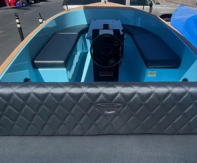 Slide: The Image of 2023 Vision Marine Technologies Volt 180 boat interior with blue seating and black quilted upholstery. - 2
