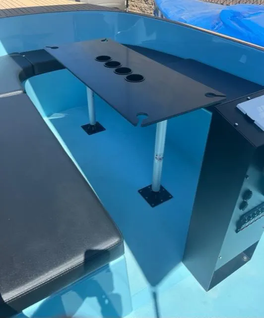 Slide: The Image of 2023 Vision Marine Technologies Volt 180 interior with seating and table setup. - 3