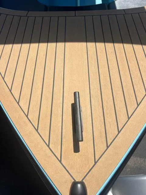 Slide: The Image of 2023 Vision Marine Technologies Volt 180 boat deck with sleek wood finish and cleat. - 5
