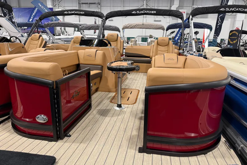 The Image of 2026 SunCatcher Fusion 324SL pontoon boat with luxurious tan seating and sleek red exterior. - 0