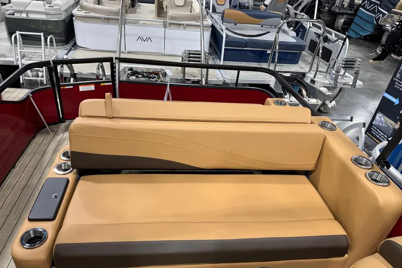 Slide: The Image of Luxurious seating on 2026 SunCatcher Fusion 324SL pontoon boat, featuring tan upholstery and cup holders. - 7