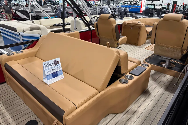 Slide: The Image of Luxurious interior of 2026 SunCatcher Fusion 324SL pontoon boat with tan seating and cup holders. - 8