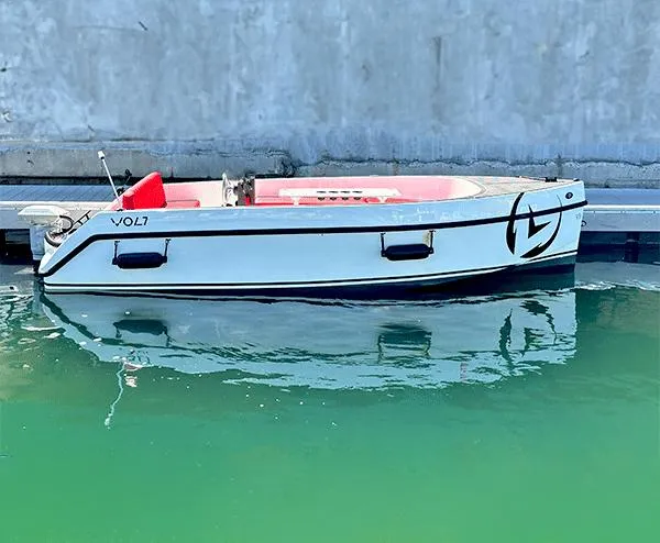 The Image of 2023 Vision Marine Technologies Volt 180 boat docked on calm water. - 0
