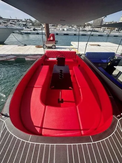 Slide: The Image of Red interior of 2023 Vision Marine Technologies Volt 180 boat at marina. - 2