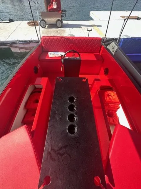 Slide: The Image of 2023 Vision Marine Technologies Volt 180 boat with vibrant red interior and seating. - 3