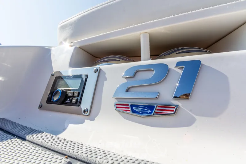Slide: The Image of 2025 Chaparral 21 SSi Ski & Fish boat with audio controls and model emblem. - 13