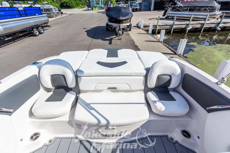 Slide: The Image of 2025 Chaparral 21 SSi Ski & Fish boat interior with comfortable seating at marina. - 15