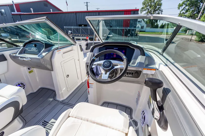 Slide: The Image of 2025 Chaparral 21 SSi Ski & Fish boat interior with modern dashboard and steering wheel. - 21