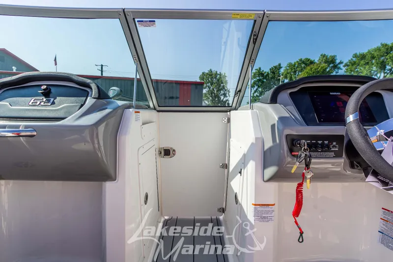 Slide: The Image of 2025 Chaparral 21 SSi Ski & Fish boat dashboard with steering wheel and controls. - 26